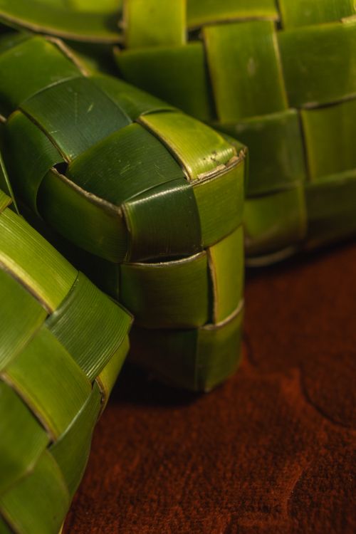 Free Detailed image of green woven ketupat rice cakes, symbolizing Eid, made with pandan leaves. Stock Photo