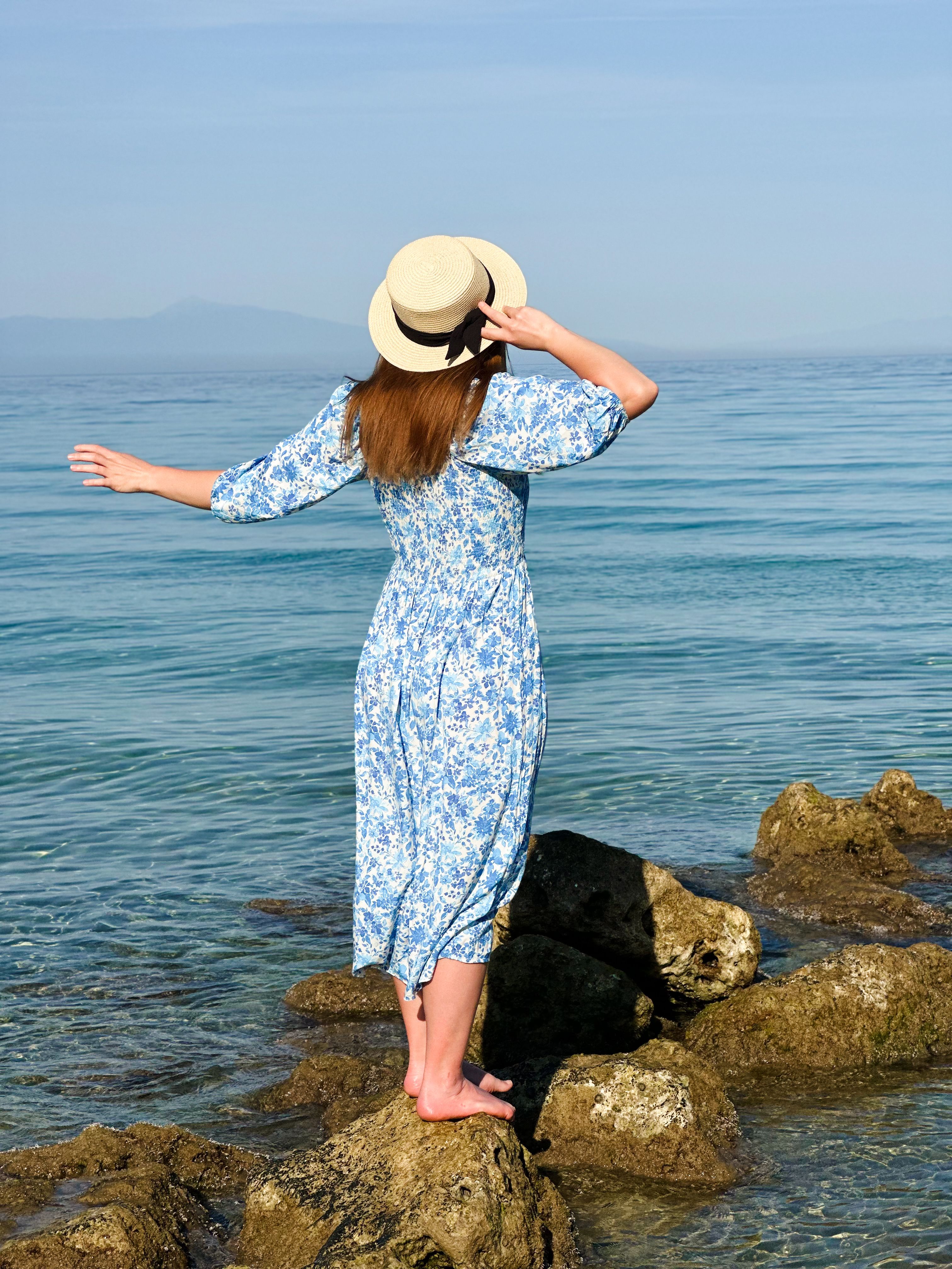 Woman in Blue Dress by the Seaside Rocks · Free Stock Photo