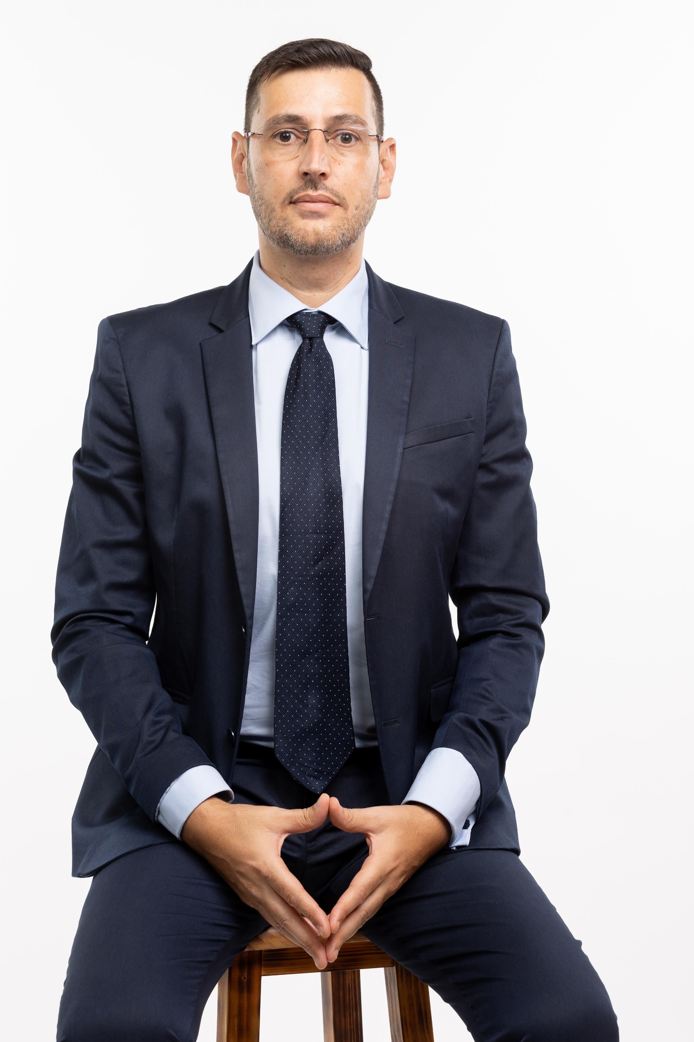 Portrait of a confident businessman sitting in a suit, conveying professionalism.