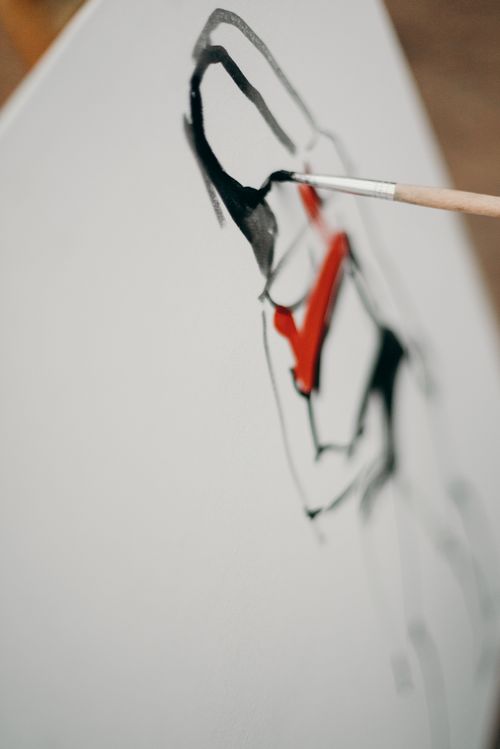 Free Close-up of an abstract painting being created with bold brushstrokes and vibrant colors. Stock Photo