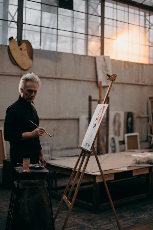 Elderly Man in Black Long Sleeves Holding a Paint Brush