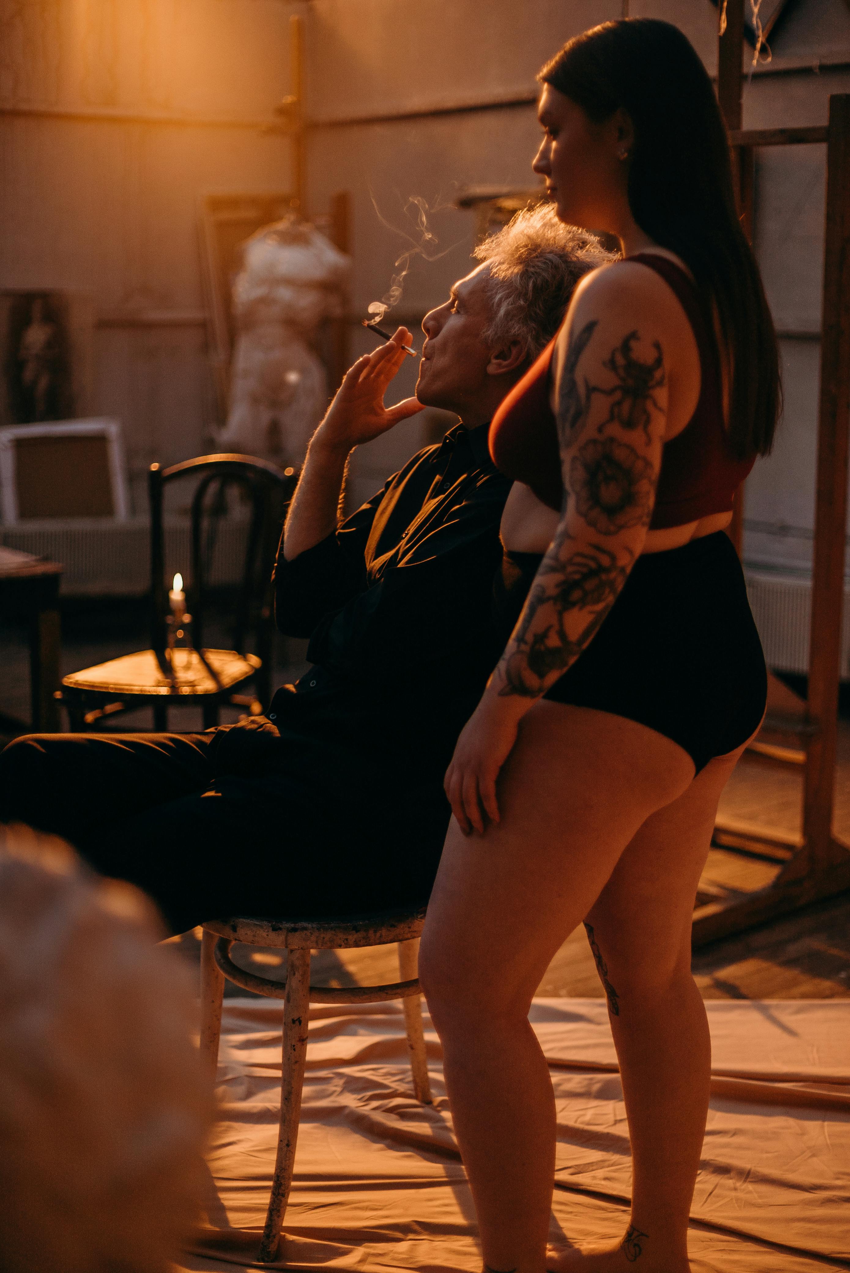 Woman in Black Underwear With Black Floral Tattoo on Her Arm