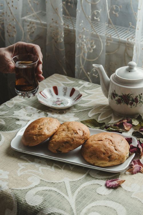 Free A cozy setup with tea and pastries on a table, perfect for a relaxing afternoon. Stock Photo