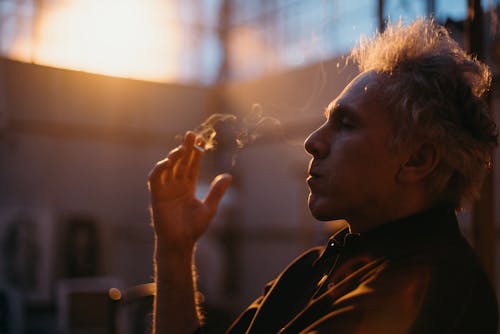 Man in Black Shirt Smoking Cigarette