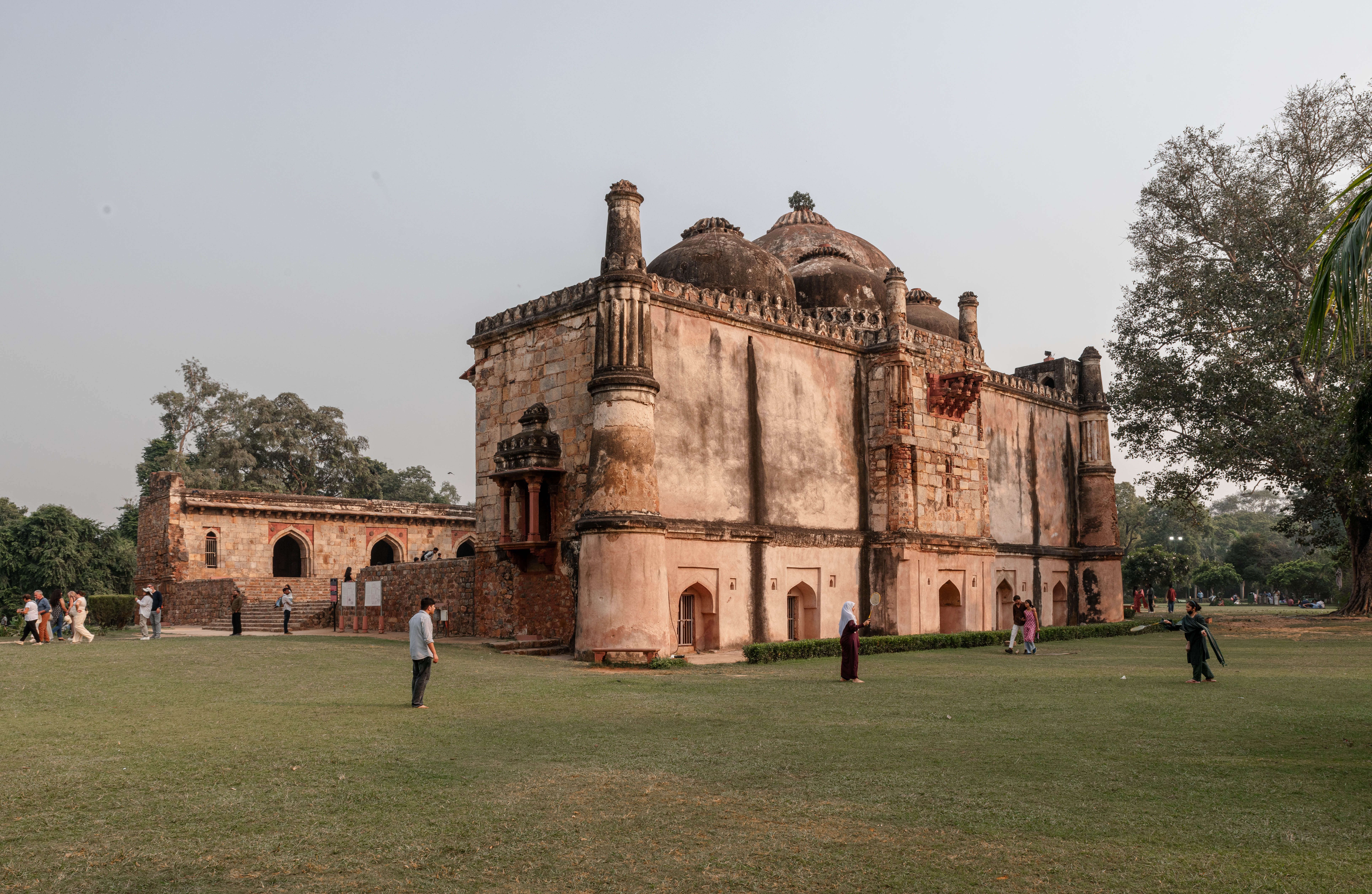 The arcaded madrasa of the Hauz Khas complex overlooking its reservoir at sunset