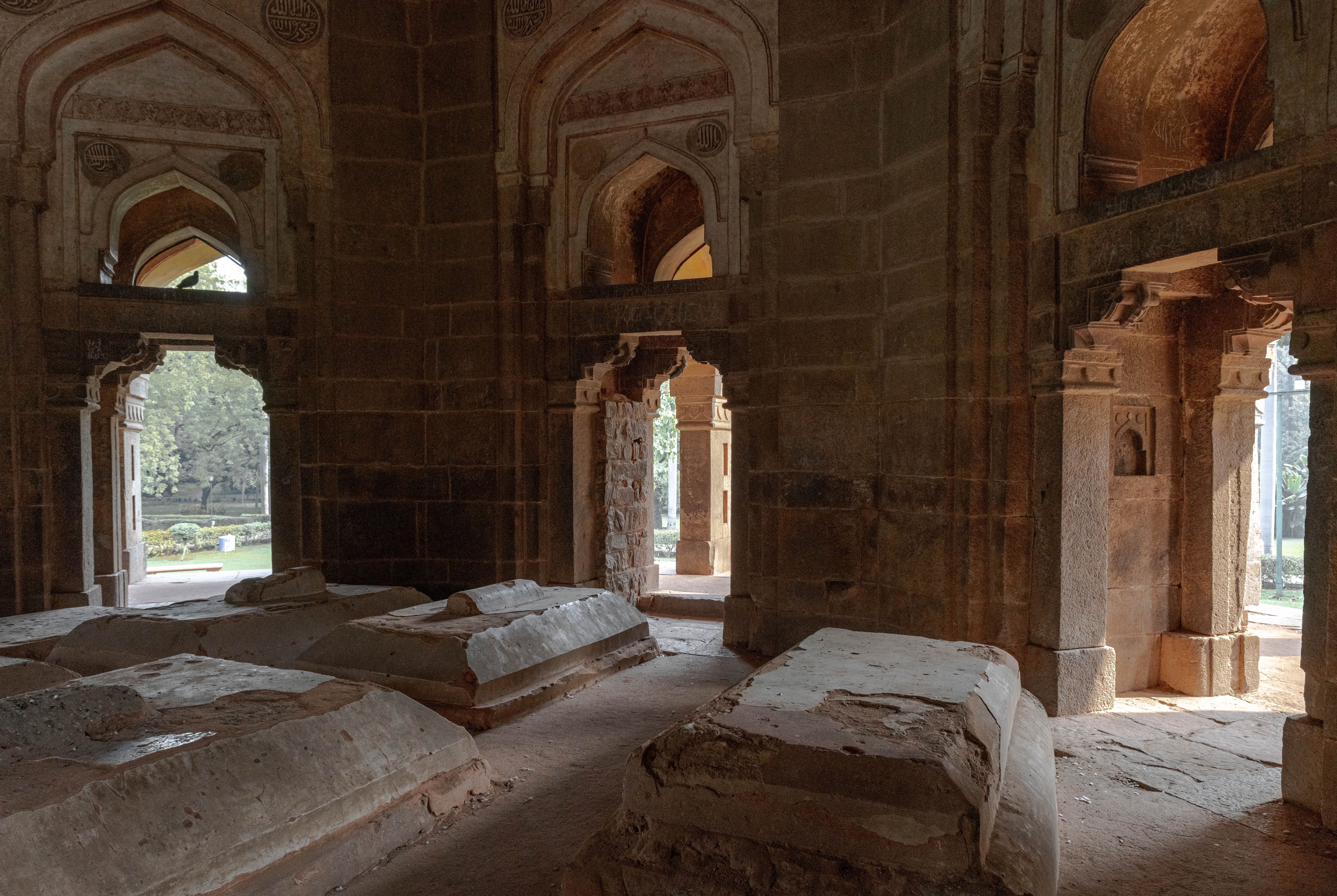 Medieval madrasa ruins beside the Hauz Khas lake at golden hour