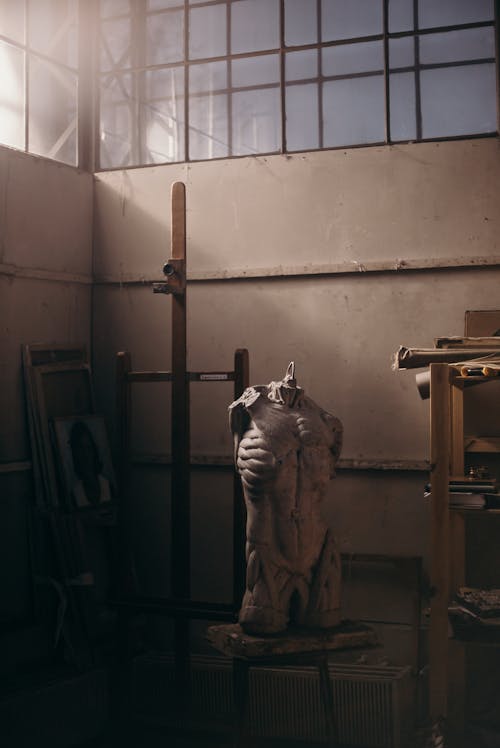 Cement Sculpture Beside Wooden Shelves