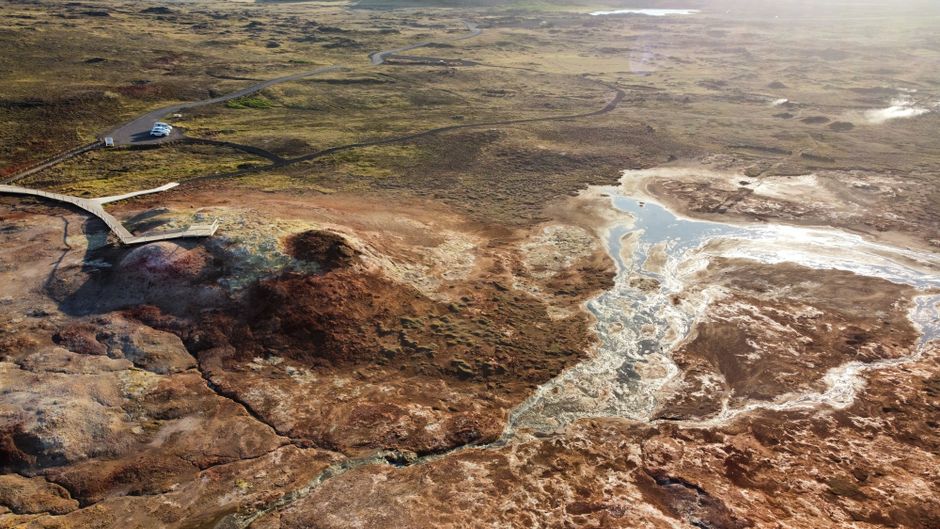 Best Helicopter Tour: Reykjavik City with landing at Mount Esja Review Review 2026 - Stunning aerial view of Iceland's geothermal landscape with boardwalk and vibrant colors.