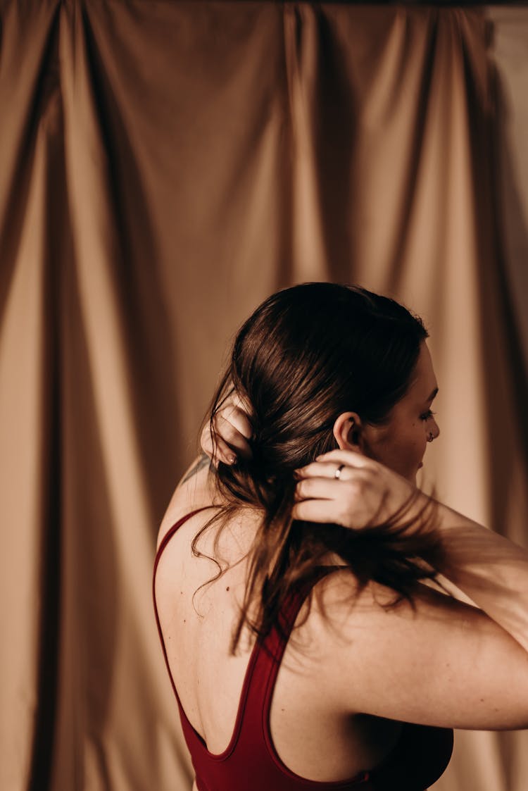 A Woman Holding Her Hair