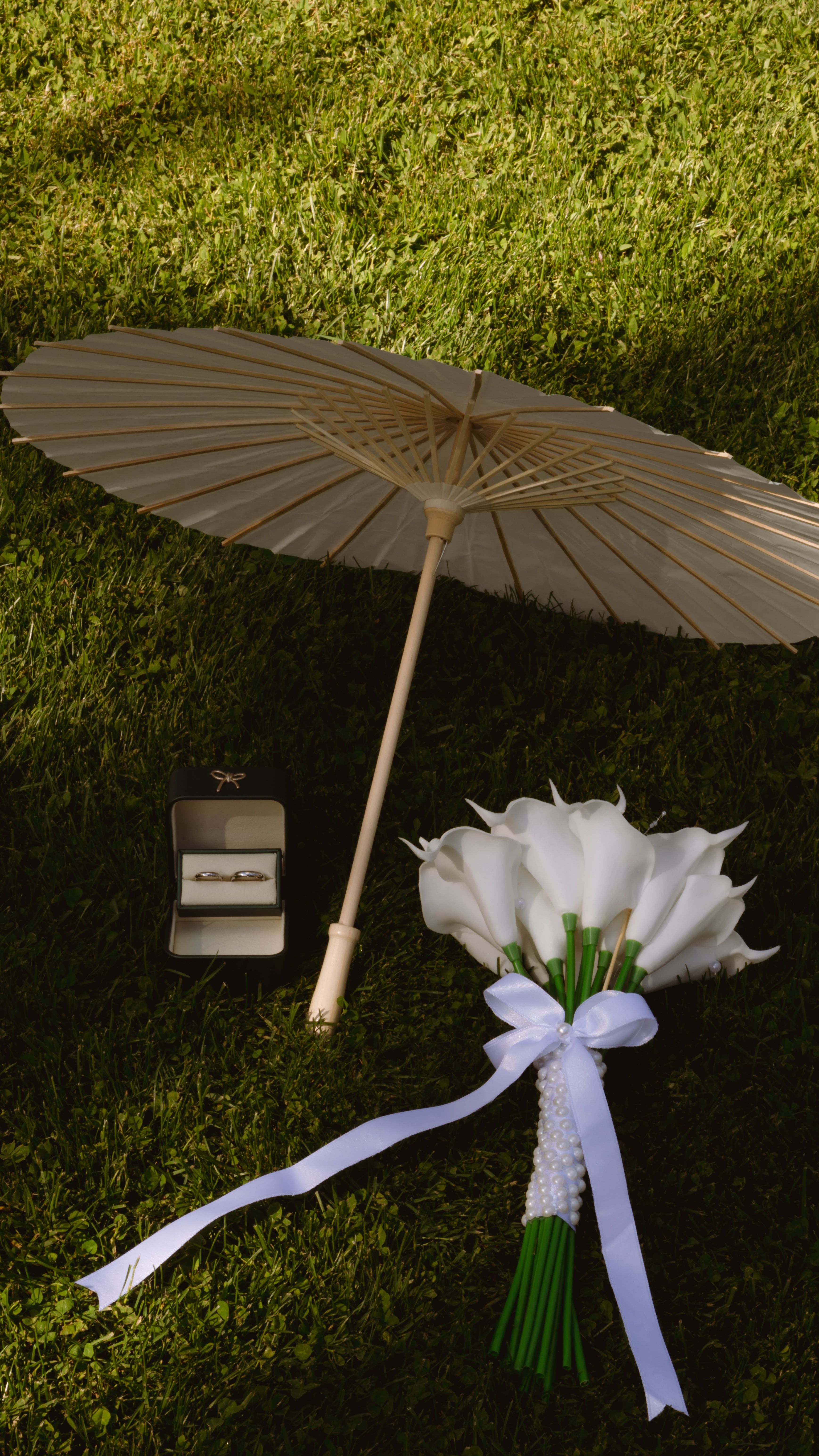 Mise en scène élégante d'un mariage avec ombrelle et bouquet