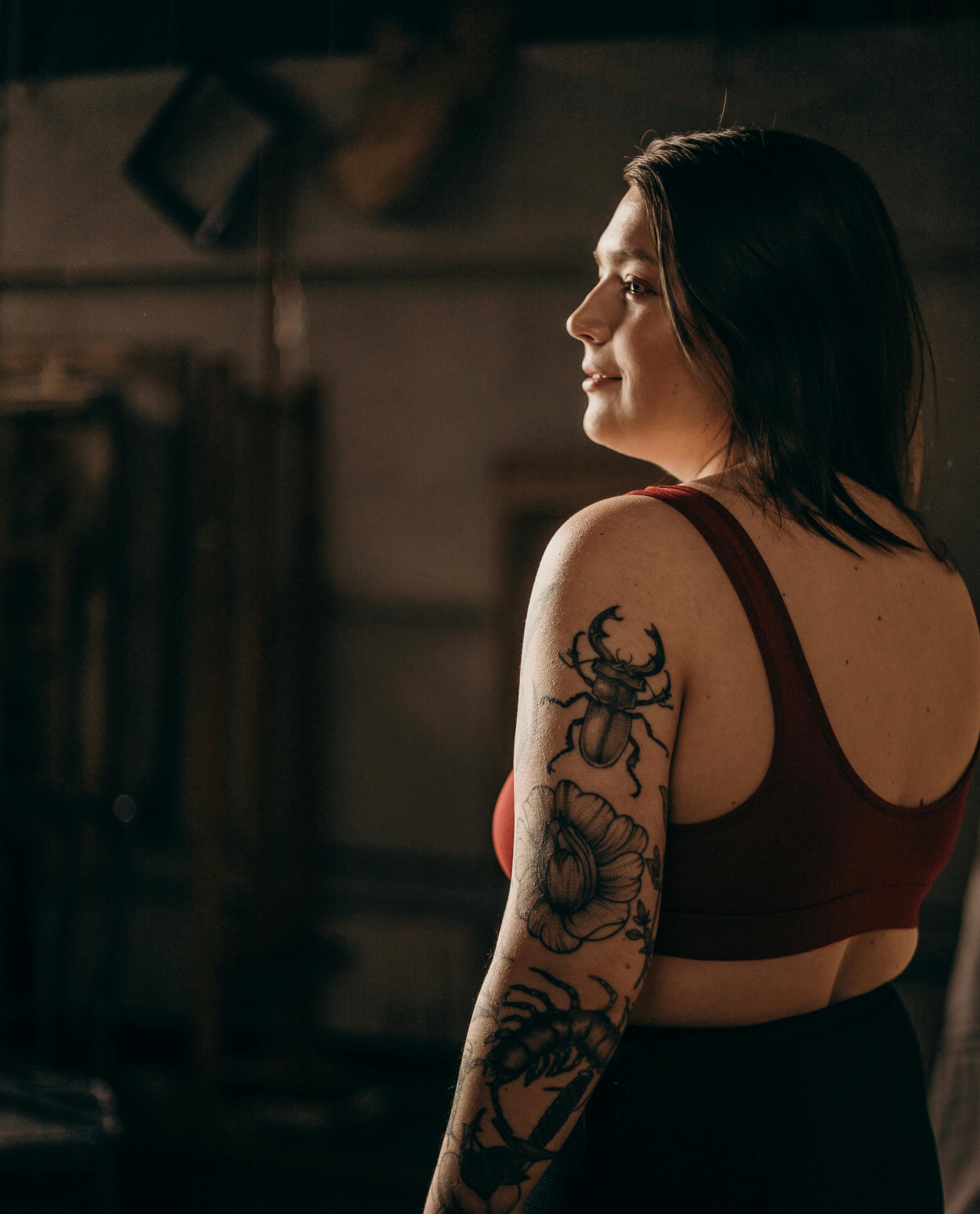 Woman In Red Tank Top With Black Floral Tattoo On Arm Free
