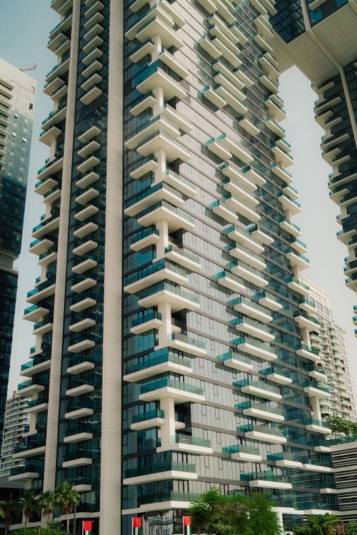 Modern High-Rise Building with Unique Architecture · Free Stock Photo