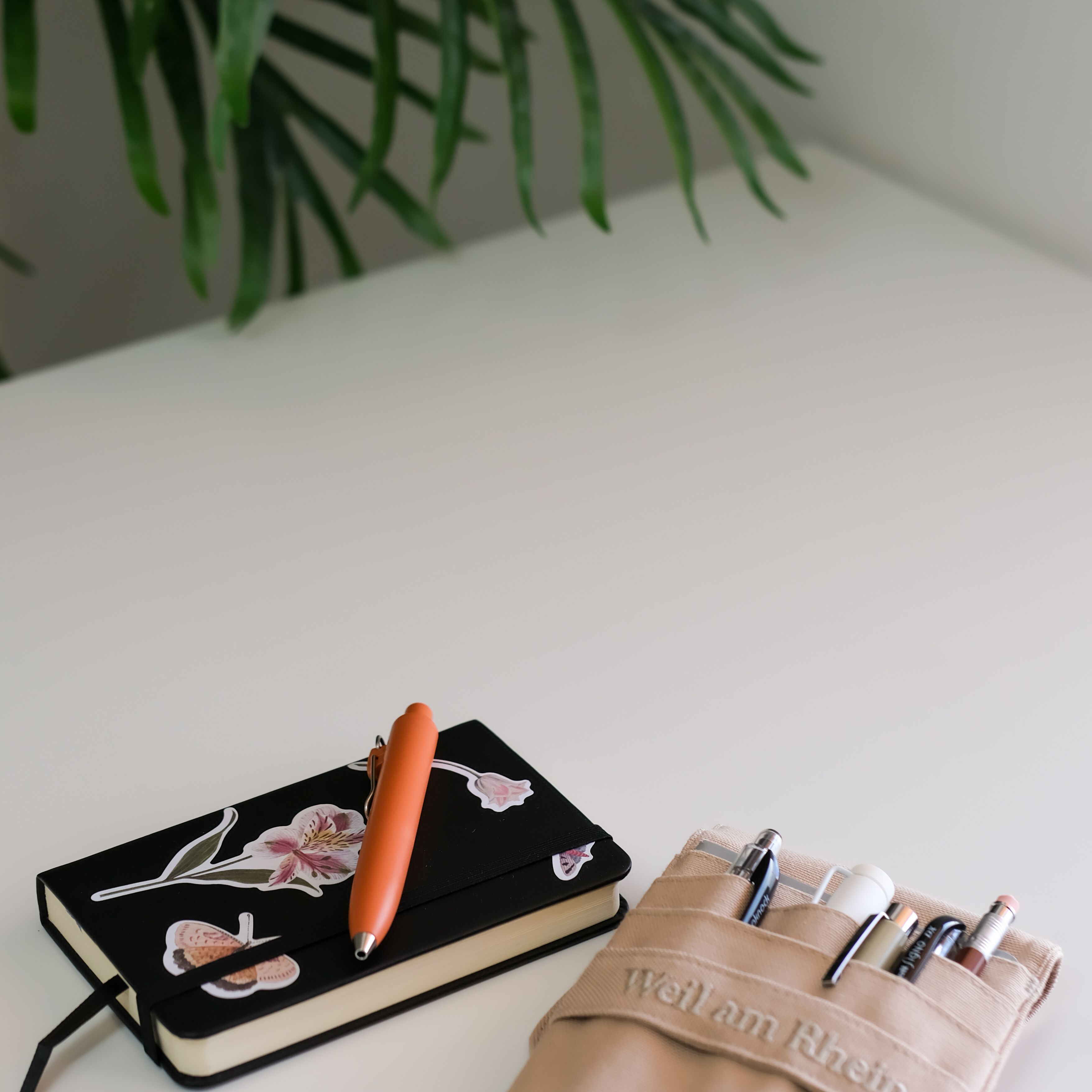 Notebook and pen on a pale desk — photo by Zeynep Hız on Pexels