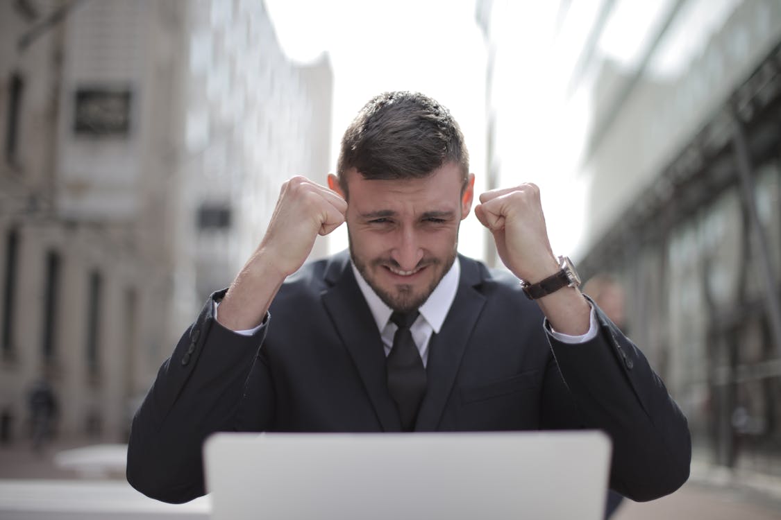 Free Man in Black Suit Achieved an Accomplishment Stock Photo