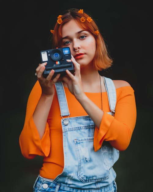 Woman Holding Polaroid Camera