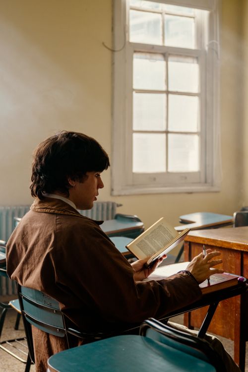 Free A university student engrossed in a book in a Buenos Aires classroom. Stock Photo