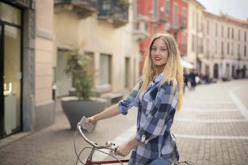 Mulher Vestindo Uma Camisa Xadrez Enquanto Segura Uma Bicicleta