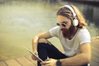 Man in White Crew Neck T-shirt Wearing Black Sunglasses
