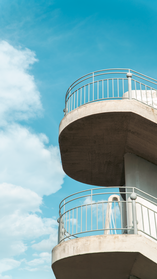 Free Concrete balcony structure with railings under sunny sky, showcasing modern architecture. Stock Photo