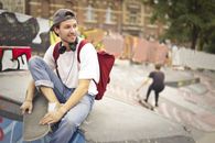 Man in White Shirt Sitting on Concrete Bench