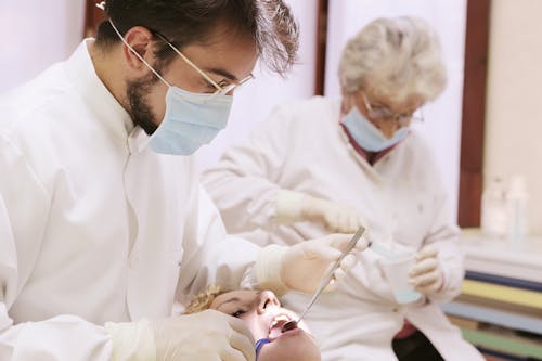 Free Dentist Looking on Woman's Mouth Stock Photo