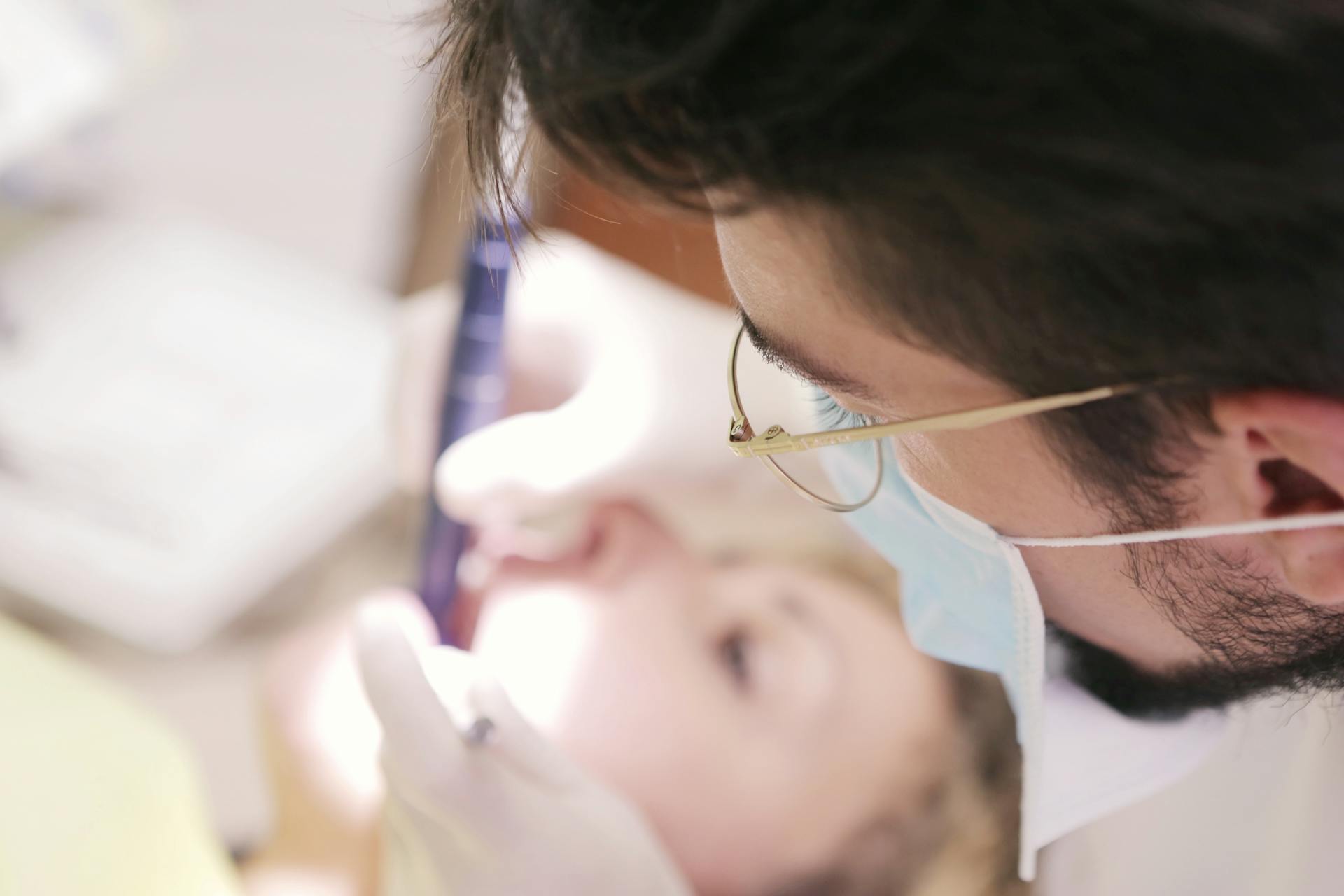 Male Dentist Working on Woman's Teeth