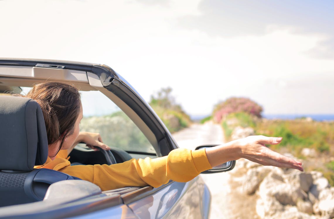 Woman in Yellow Long Sleeve Driving Car