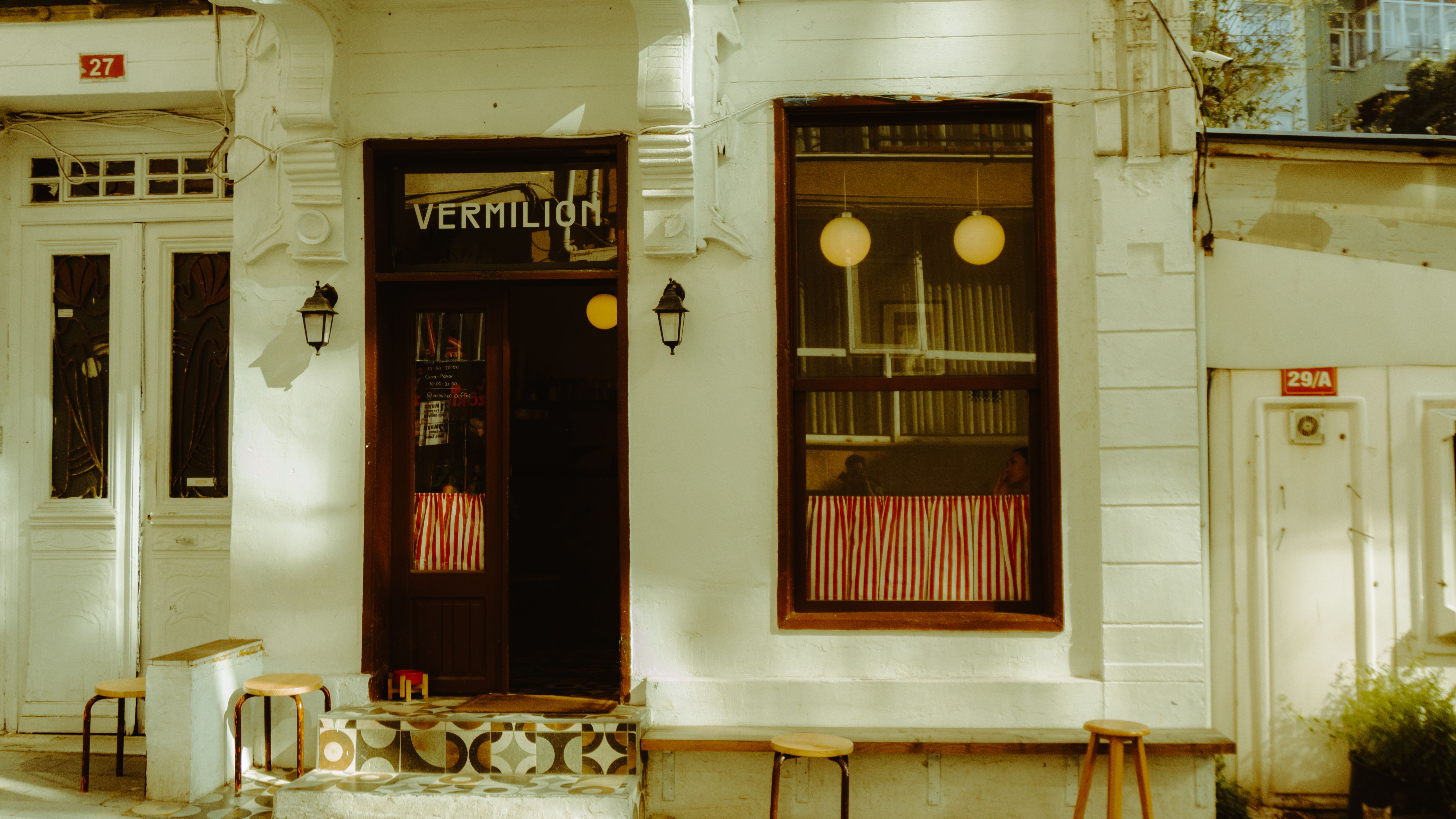 Cozy local coffee shop in Panama City with a barista preparing a 'café con leche'.