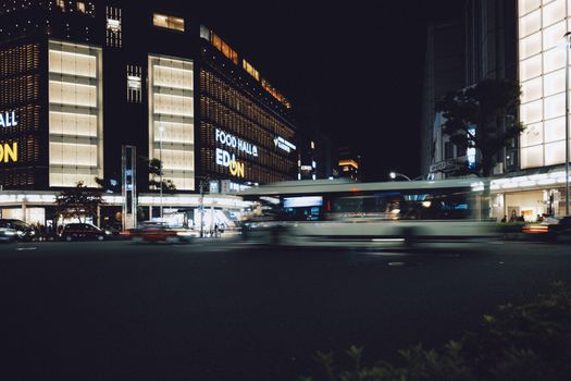 City nightlife with blurred traffic and illuminated buildings.