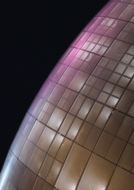 A close-up of a modern, illuminated architecture facade in Seoul showcasing geometric patterns and vibrant colors.