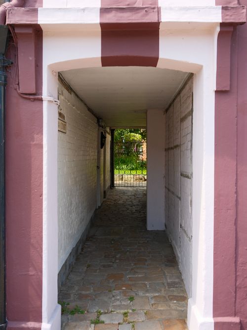 Free Discover a hidden garden through this enchanting narrow archway in Marlborough, England. Stock Photo