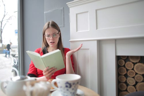 Photo of  a Woman Reading Book
