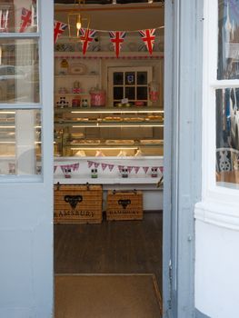 Discover a cozy bakery in Marlborough with festive Union Jack bunting and delightful treats.