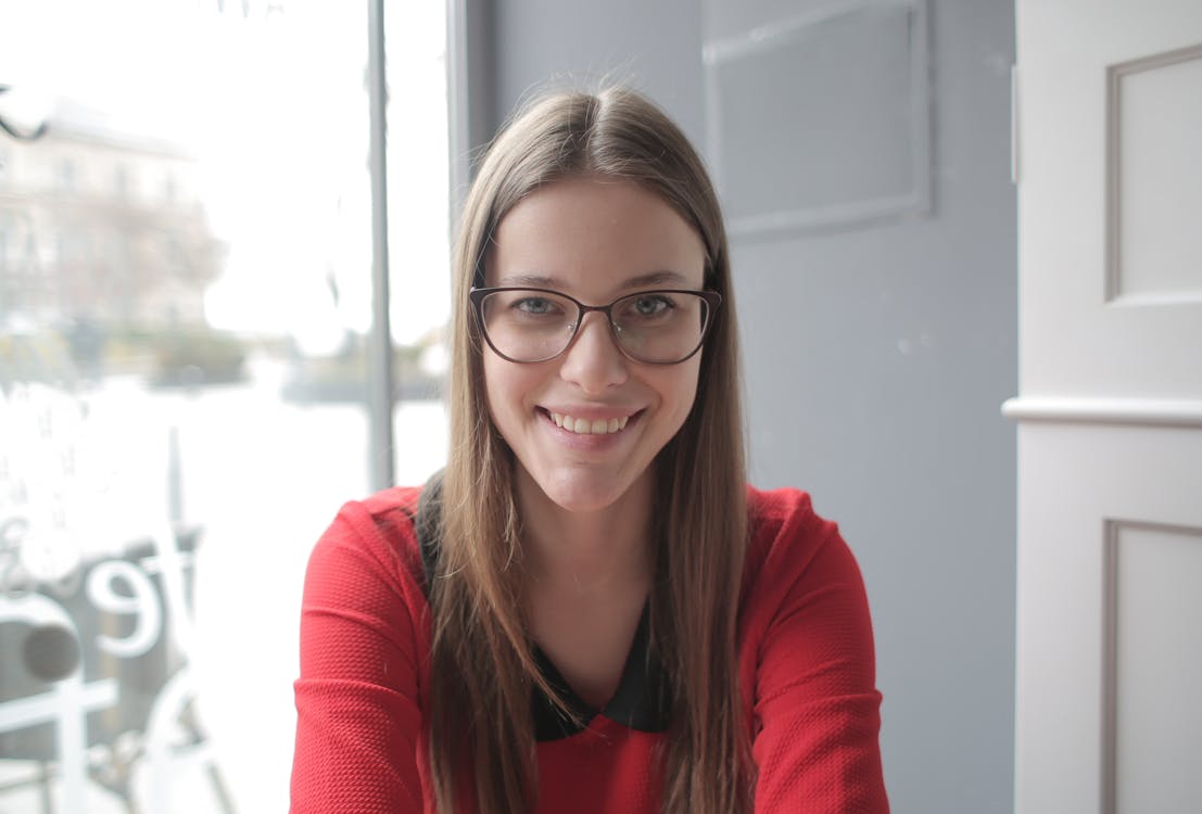 Woman in Red Shirt Wearing Eyeglasses