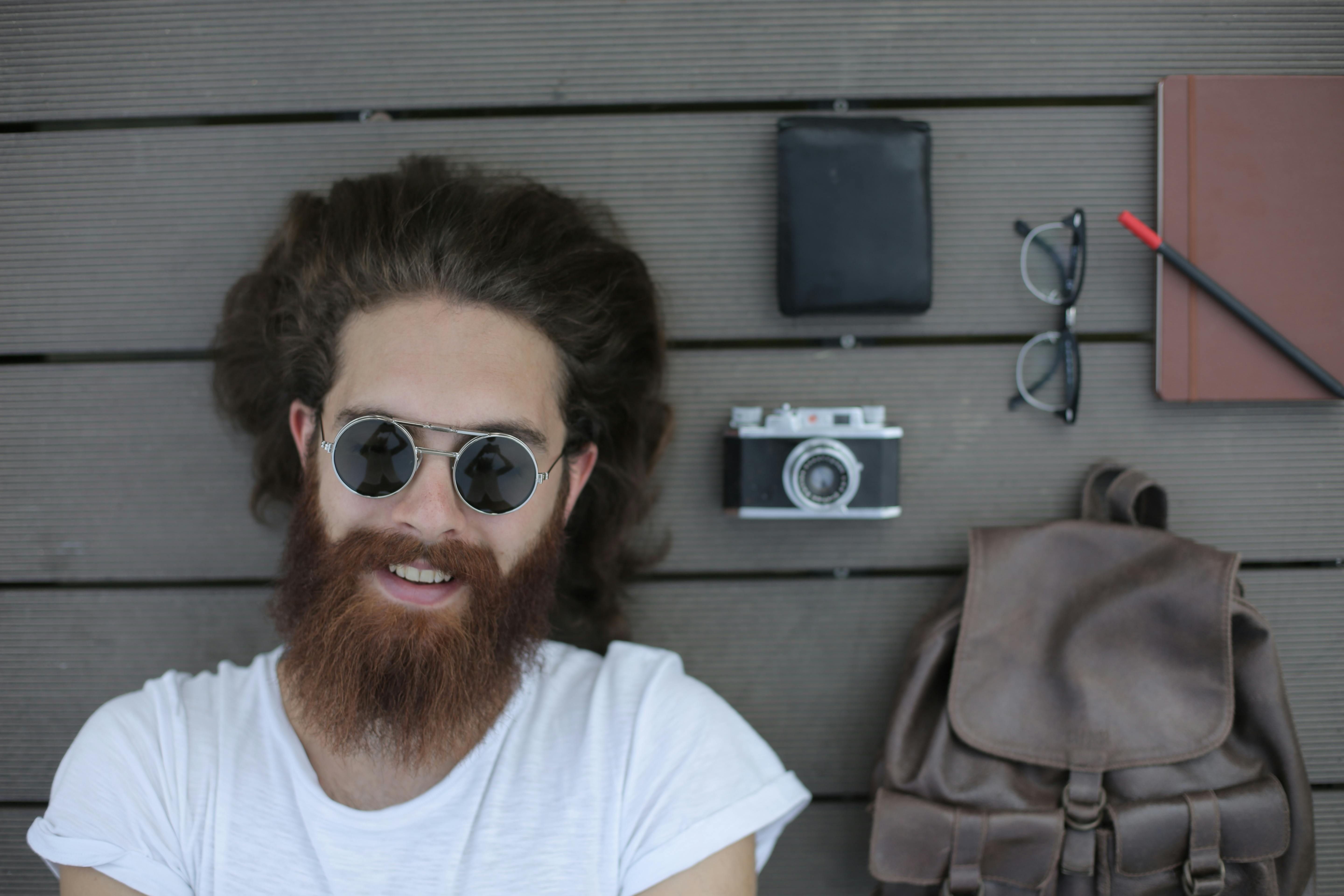 man in white shirt wearing silver framed sunglasses