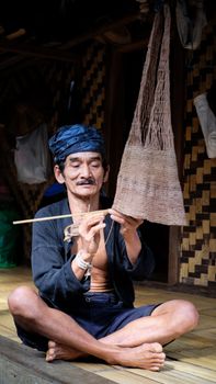 Indonesian man crafting traditional items in Banten, demonstrating cultural heritage. - Fotografer Sidoarjo
