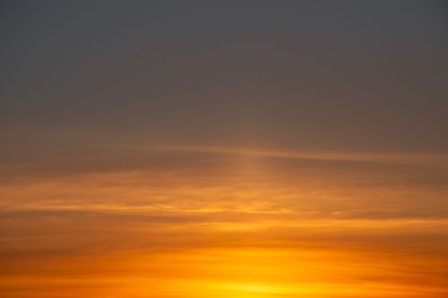 Free Serene view of a vibrant sunset with warm, colorful skies over a tranquil horizon. Stock Photo