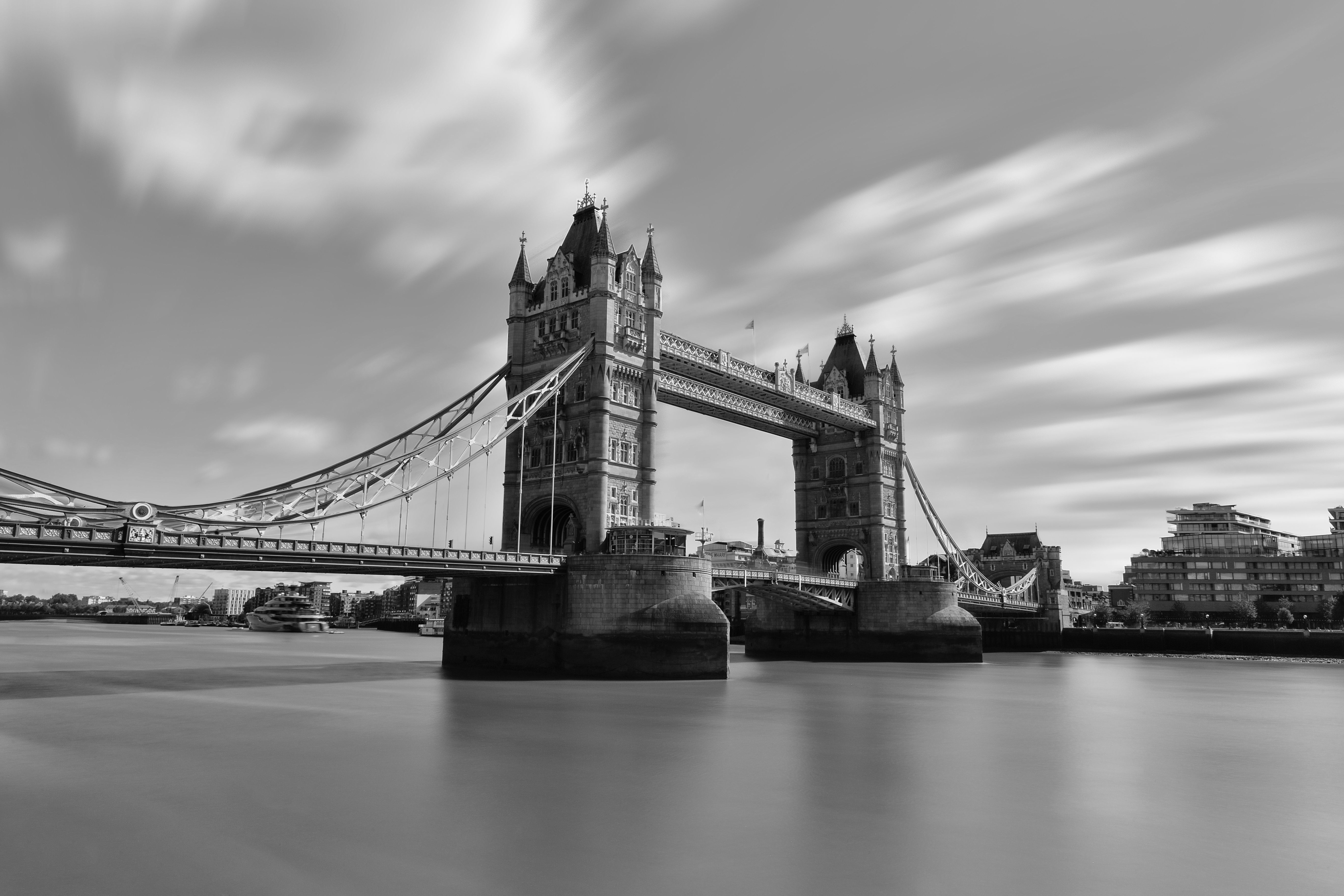 A stunning black and white long exposure photo of London's iconic Tower Bridge over the River Thames.
