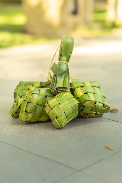 Free Freshly woven ketupat rice cakes on a sunny day in Makassar, Indonesia. Stock Photo