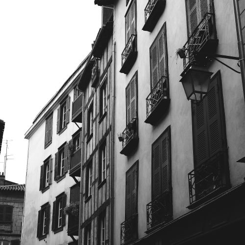 Free Discover the historic charm of Bayonne's old town with classic French architecture and shutters in black and white. Stock Photo