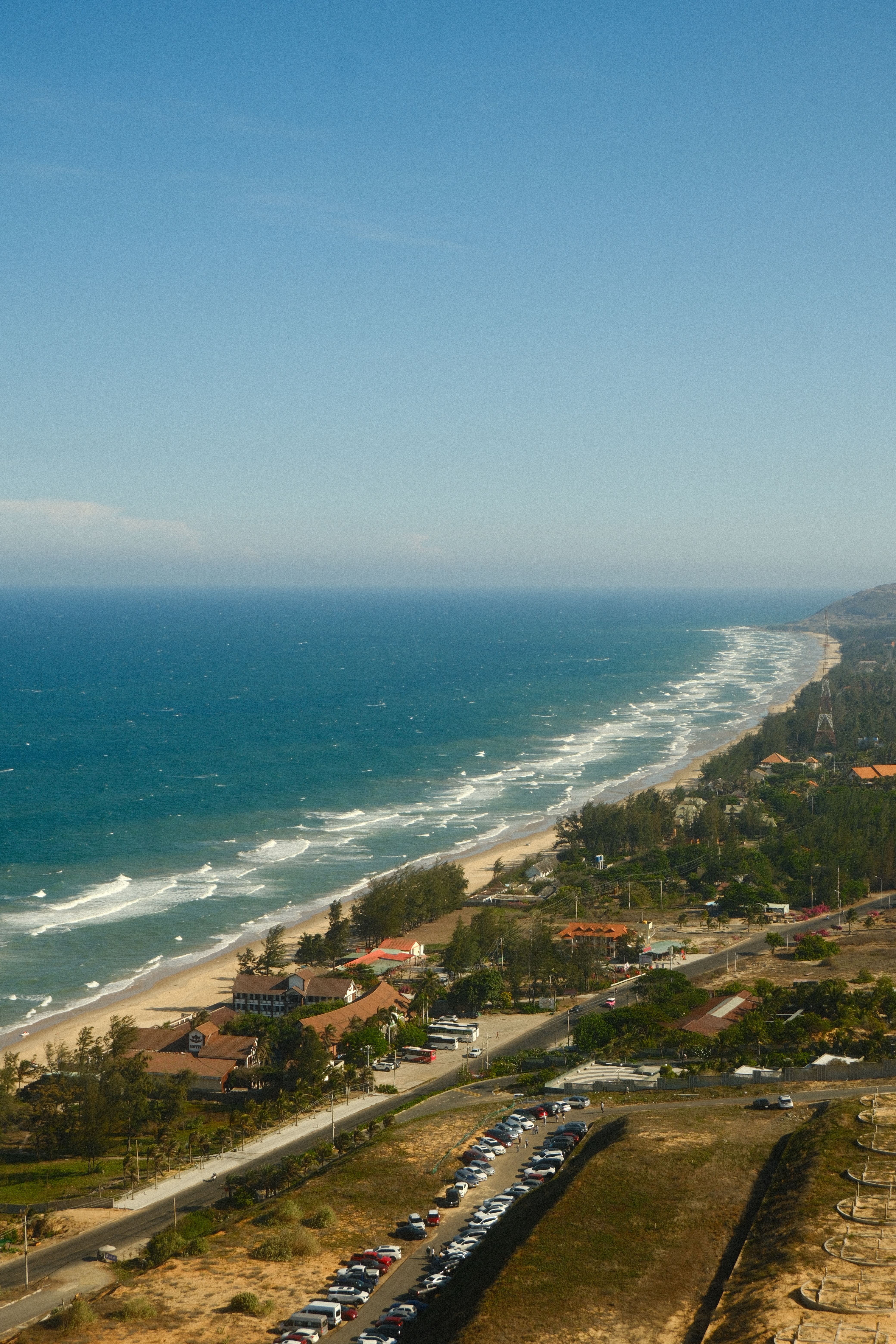 Stunning aerial view of the Mui Ne coastline in Bình Thuận, Vietnam showcasing blue seas and sandy beaches.