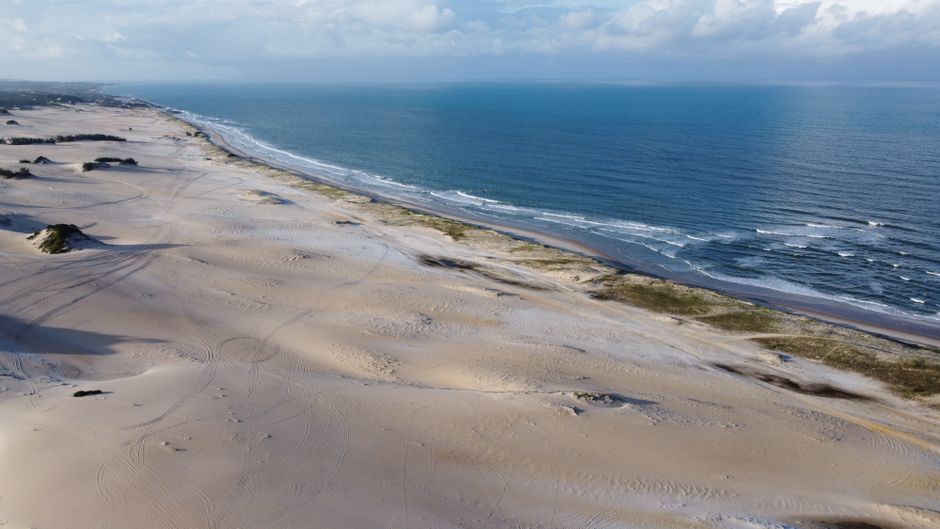 Breathtaking aerial view of Natal's sandy beach and sparkling ocean waters, capturing the serene beauty of Brazilian landscapes.