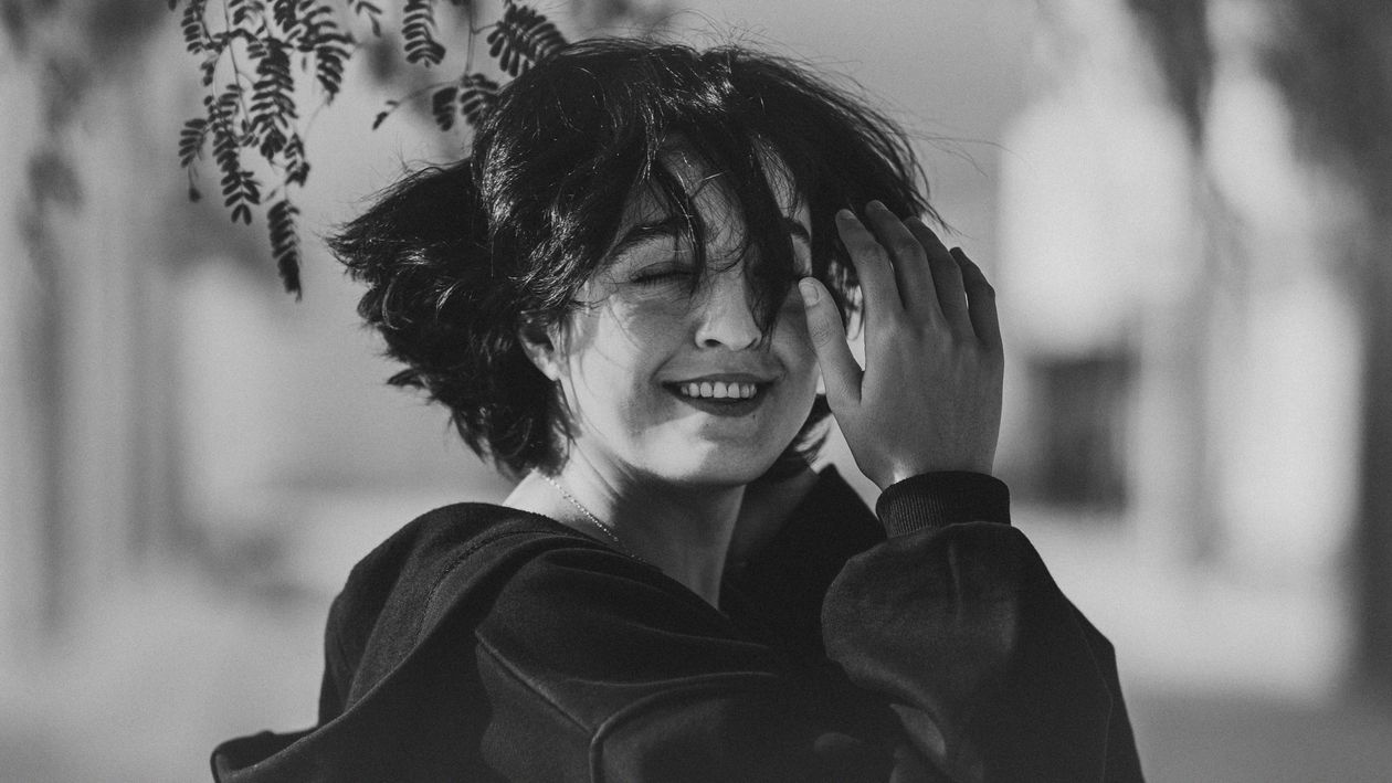 Moody Black and White Portrait of Smiling Woman · Free Stock Photo