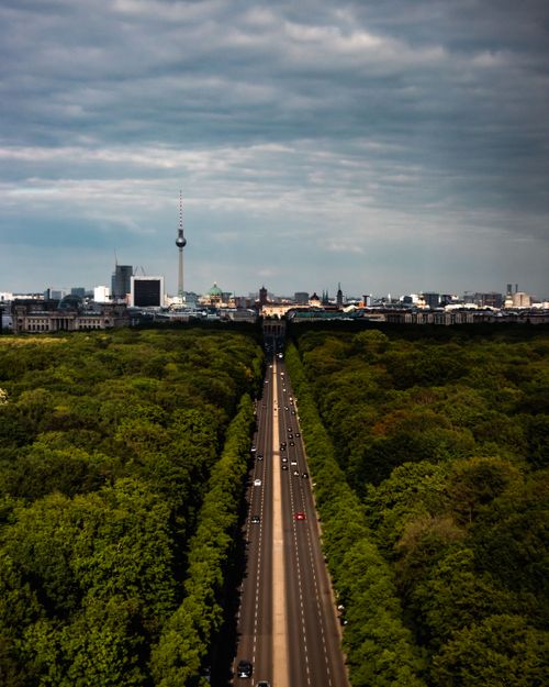 Free Aerial view of Berlin's Tiergarten and TV Tower under dramatic skies, showcasing urban and natural contrast. Stock Photo