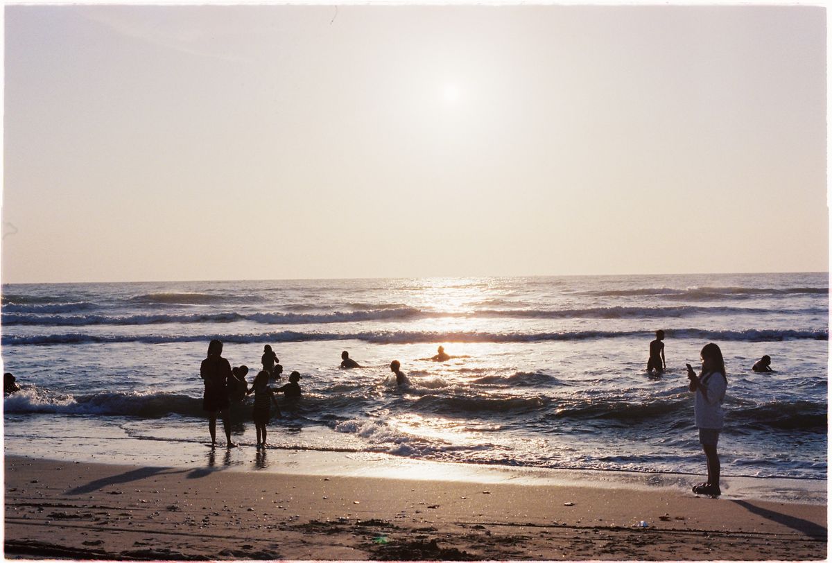 People on the beach at sunset in Mui Ne