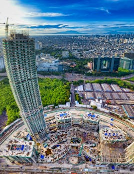 Stunning aerial shot showcasing Jakarta's skyline and a prominent skyscraper under construction.