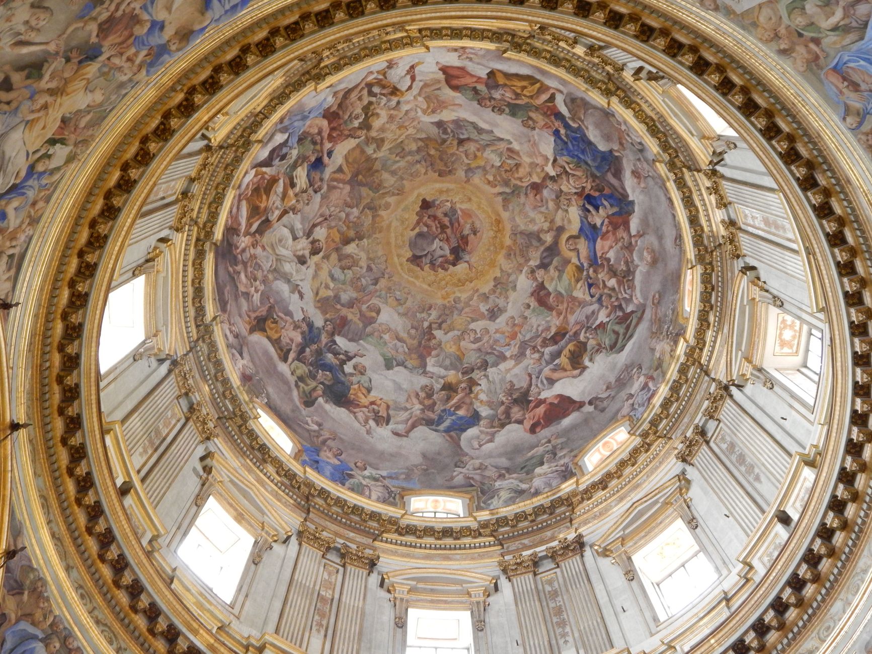 Exquisite baroque dome fresco in an Italian church, showcasing intricate religious artwork.