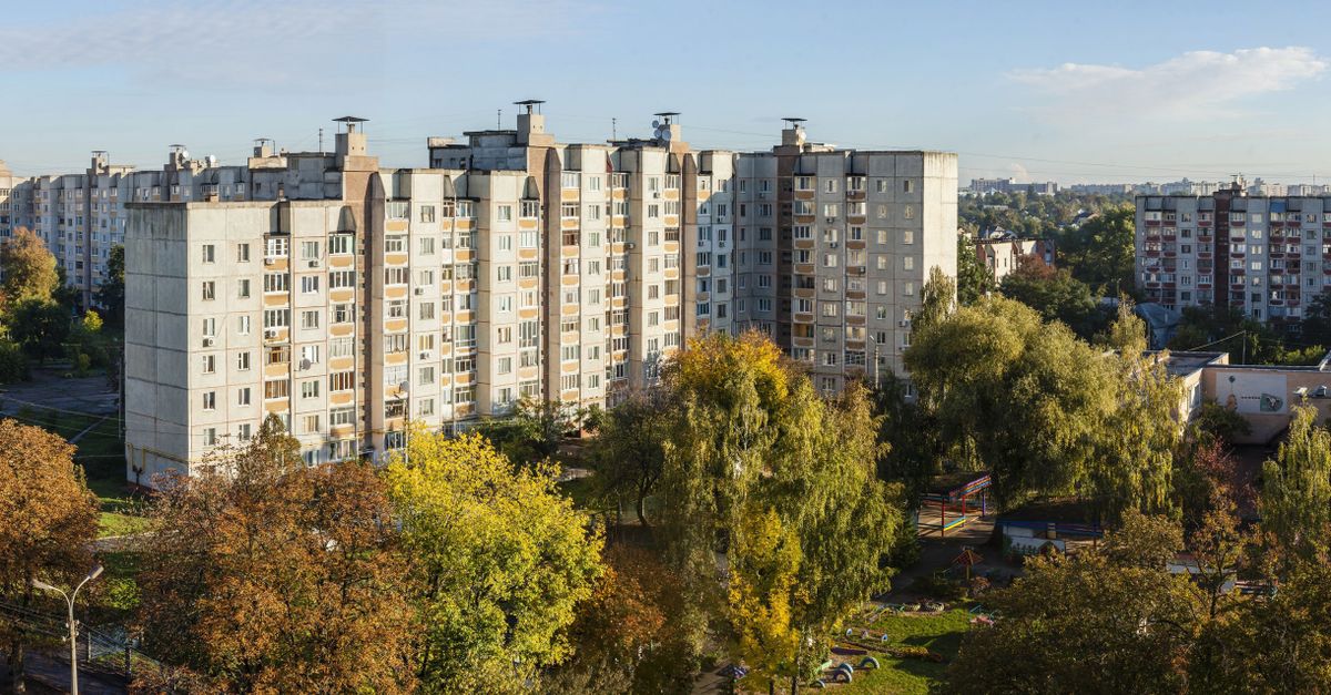 Aerial view showcasing residential apartment buildings amidst autumn foliage in Chernihiv, Ukraine.