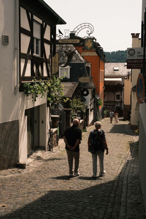 Free Serene stroll down a cobblestone street in historic Rüdesheim, Germany, showcasing traditional architecture. Stock Photo
