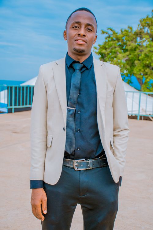 Elegant Young Man in Suit on a Rooftop · Free Stock Photo